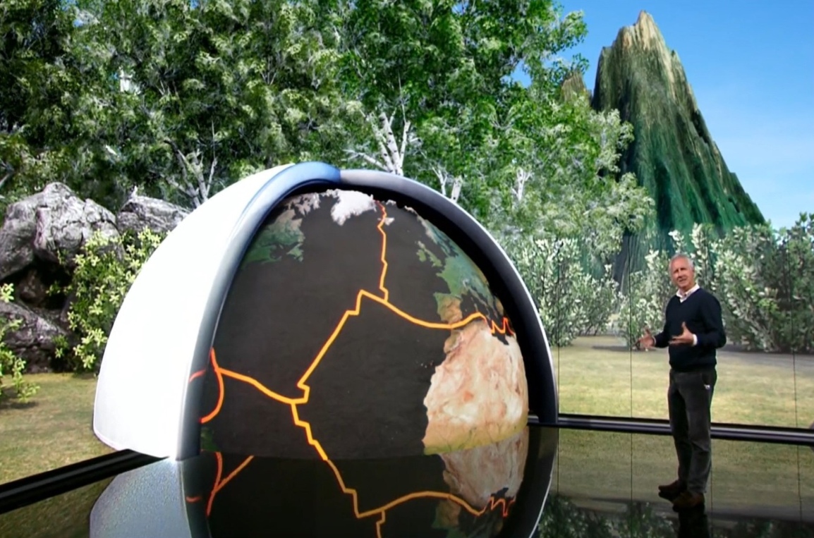Realidad aumentada del especial de TVE sobre la erupción de La Palma, con un presentador junto a un globo terráqueo virtual y el volcán Cumbre Vieja recreado al fondo.