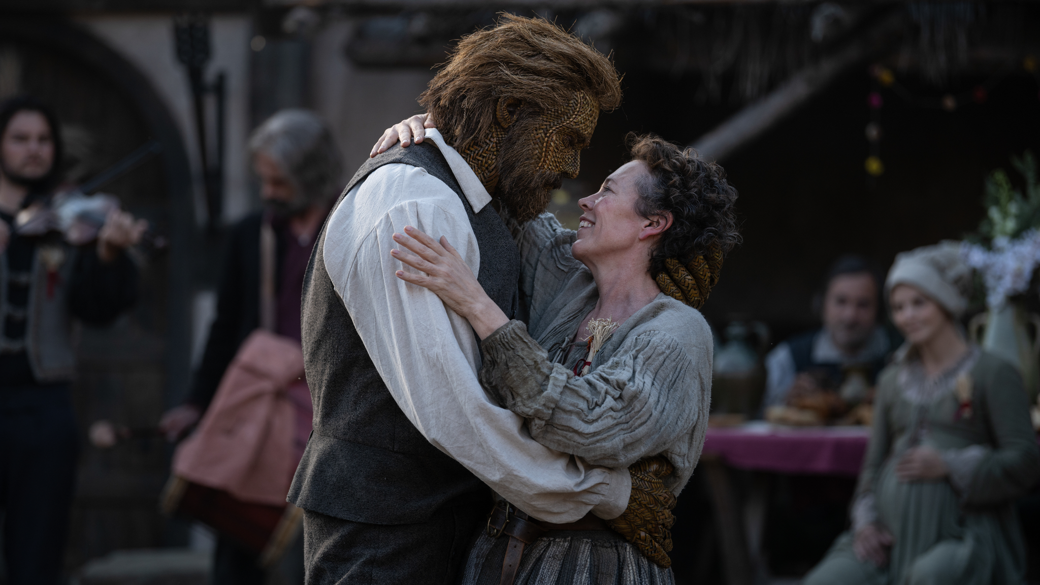 The Wicker Husband embraces the Fisher Woman as villagers gather behind them in a scene from Wicker