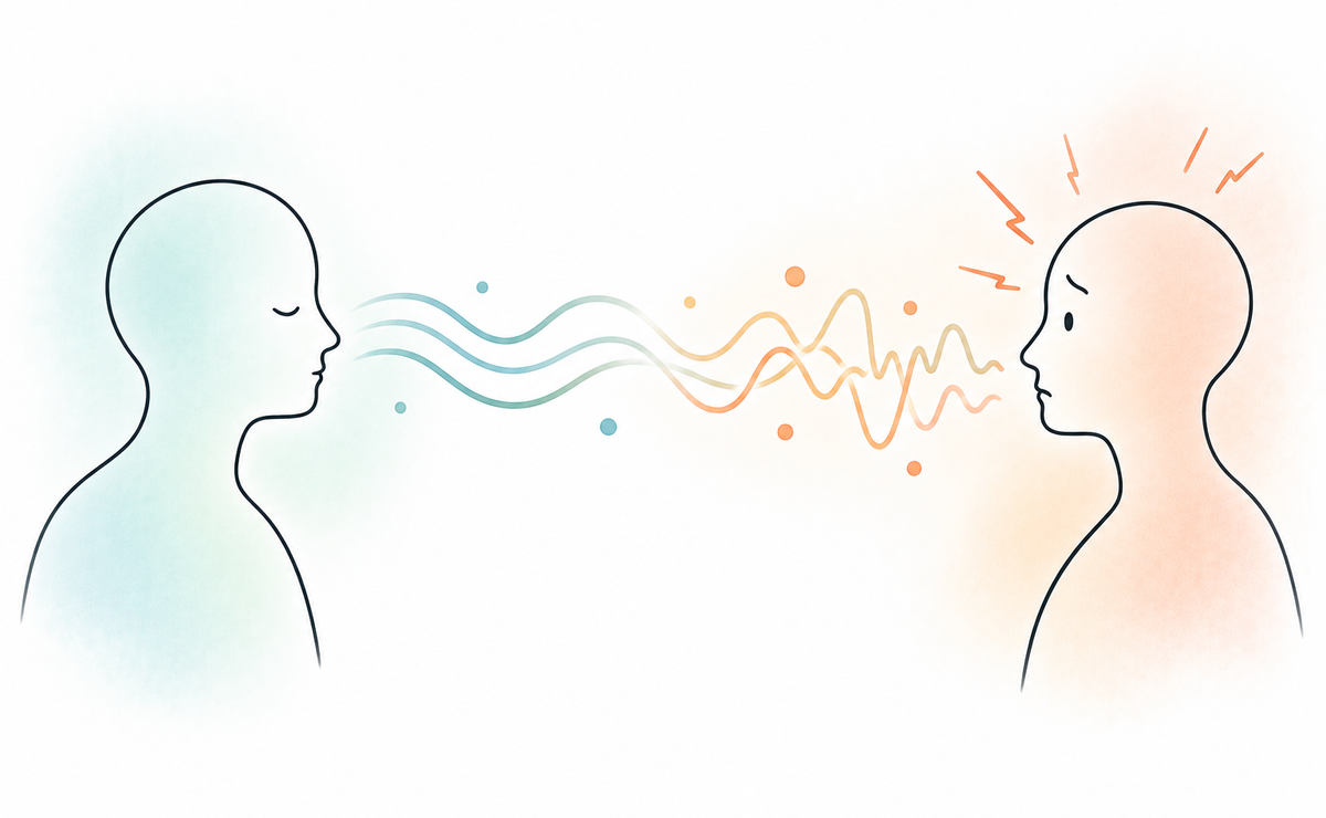 Two people face each other as calm signals become distorted between them, illustrating how differences in communication can lead to rapid misunderstanding and negative first impressions.