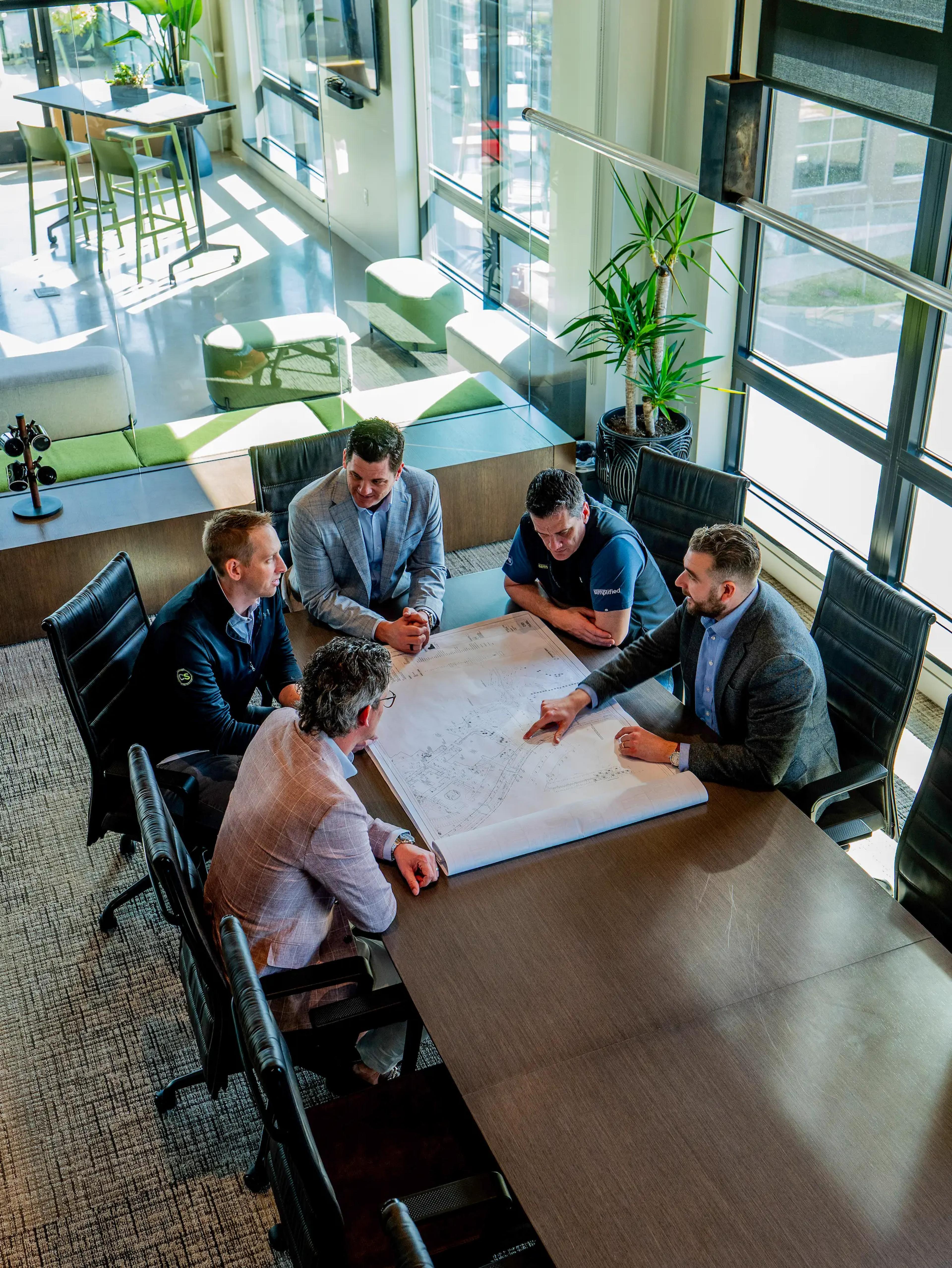 Owner's representative with project team on construction site