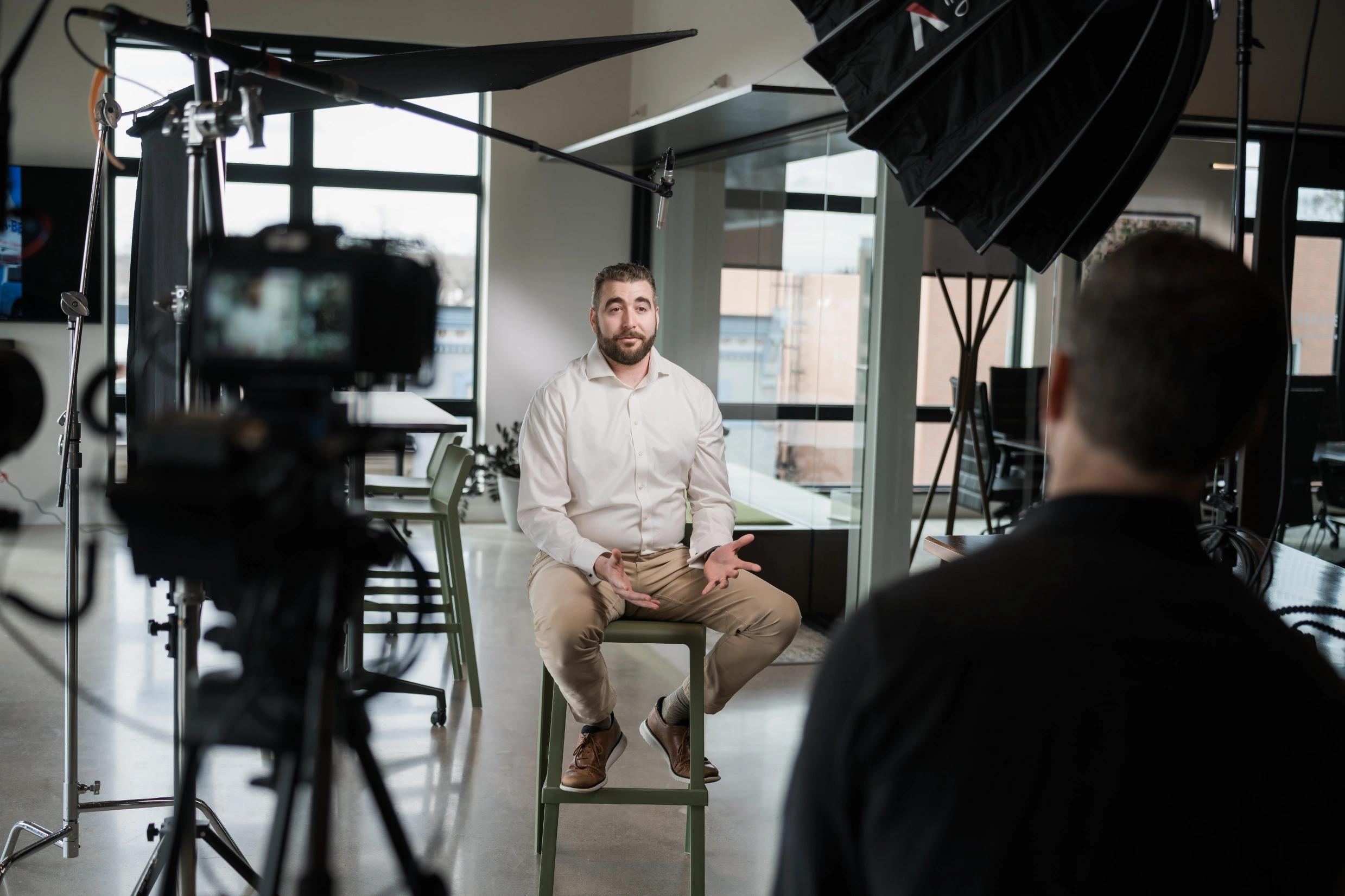 Travis being interviewed by camera crew on 4th floor