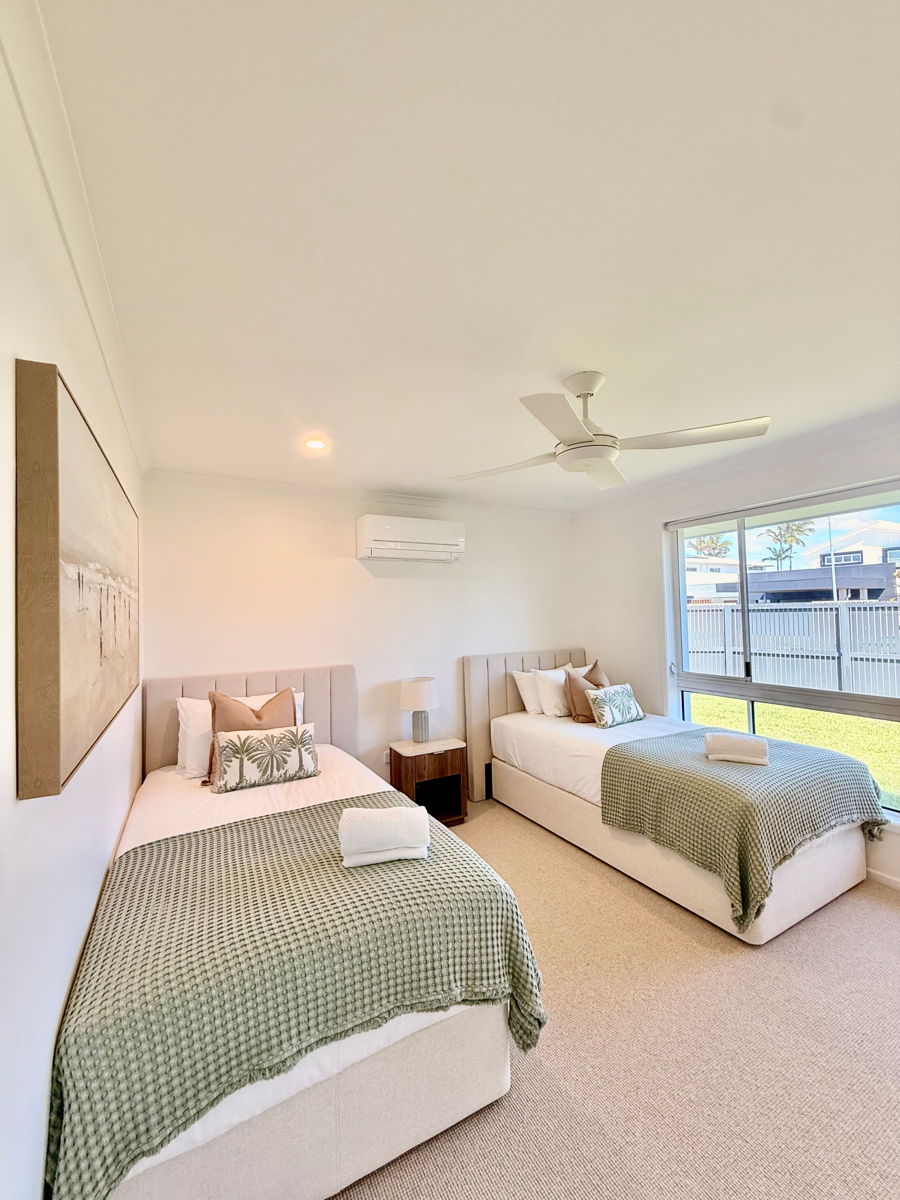 Wall-mounted split-system air conditioner installed in a second bedroom of the holiday rental