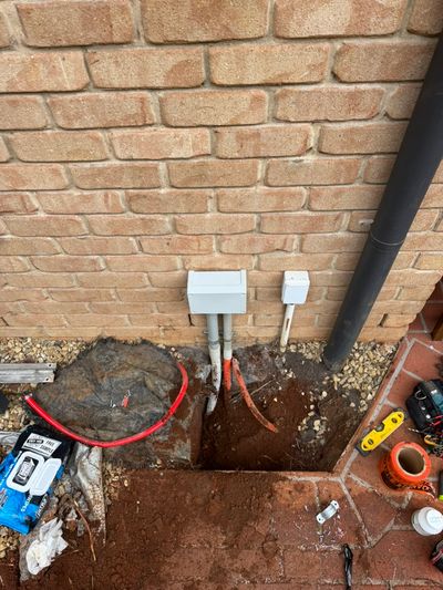 New wall boxes and conduits on a brick elevation where the sub-main enters the house