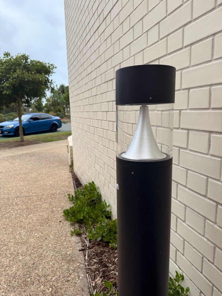 Repaired path bollard against a white brick wall at The Curl, Bokarina
