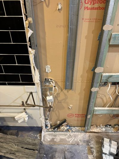 First-fix power and lighting in a wet-area wall during the Good Eats Mooloolaba renovation