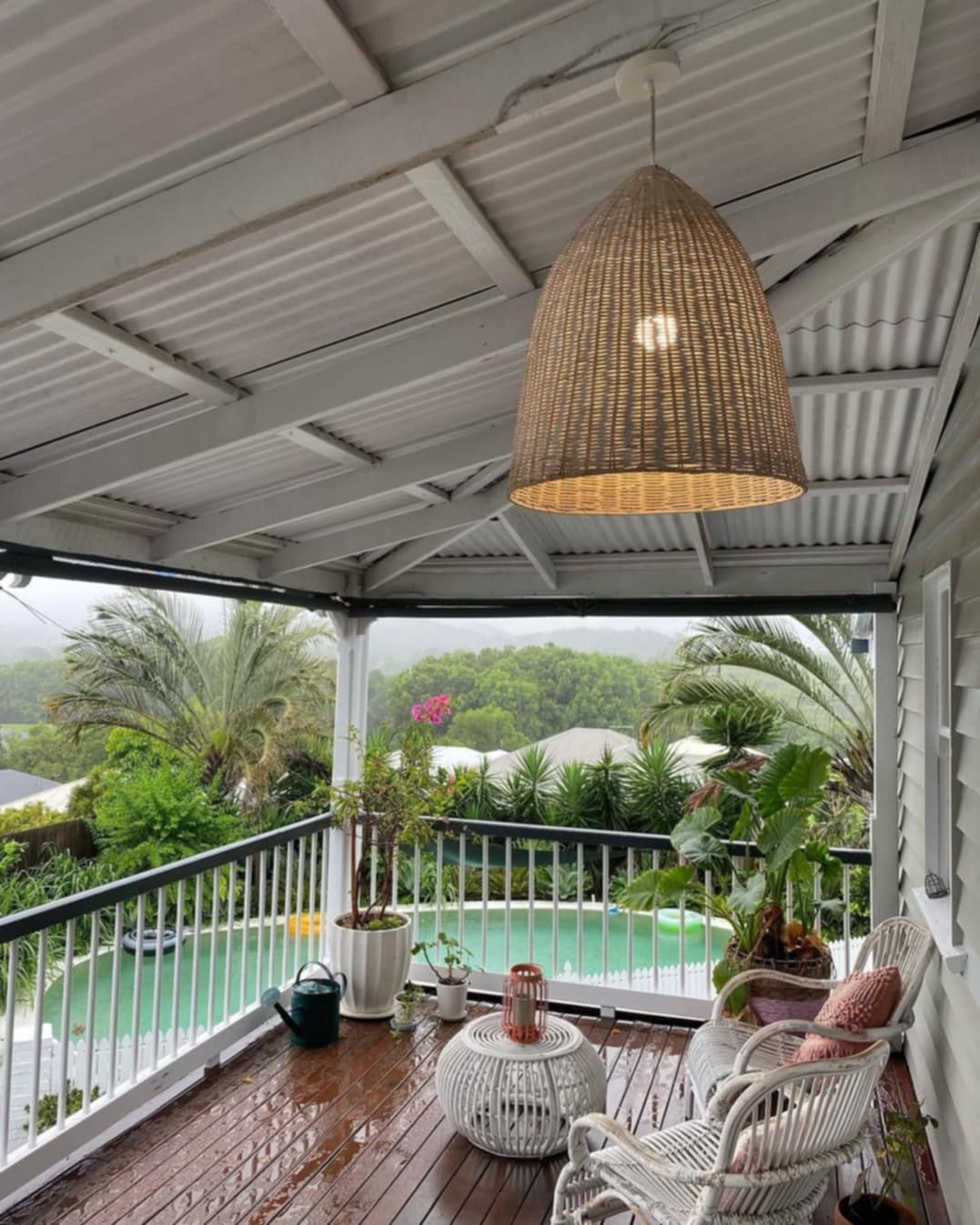 Large wicker pendant light on covered timber verandah