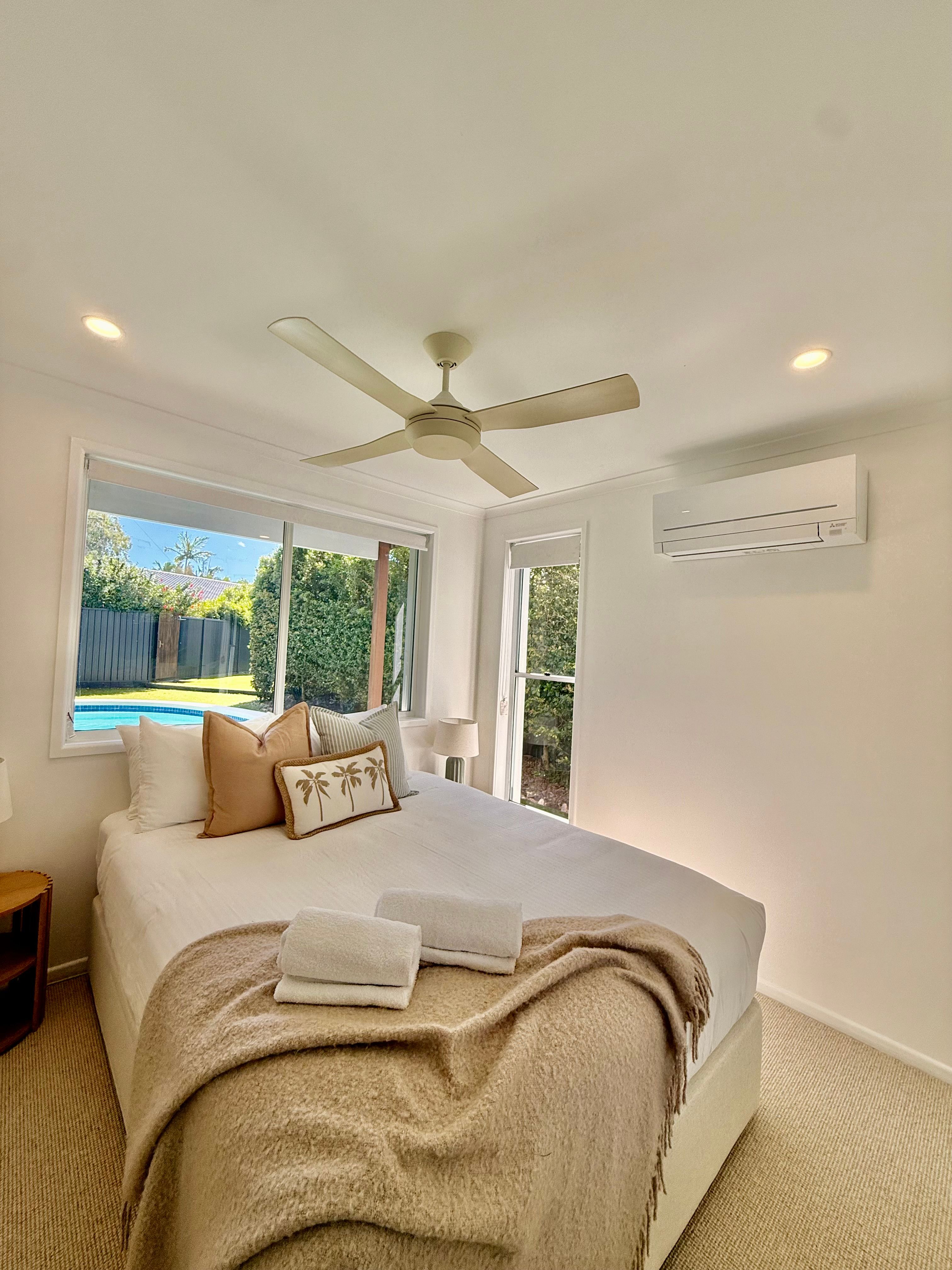 Wall-mounted split-system air conditioner installed in an Airbnb bedroom