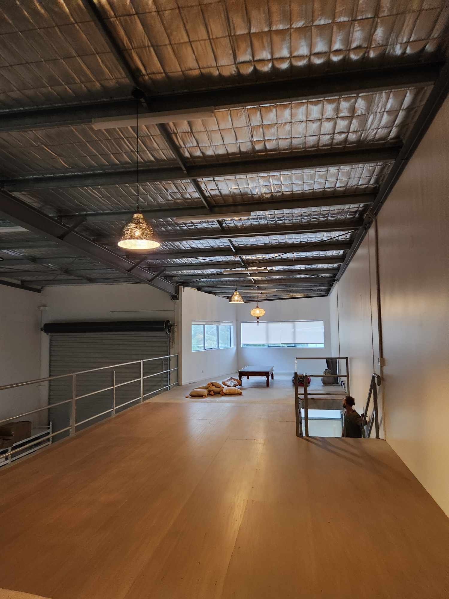 Hanging pendant lights across mezzanine floor in commercial building