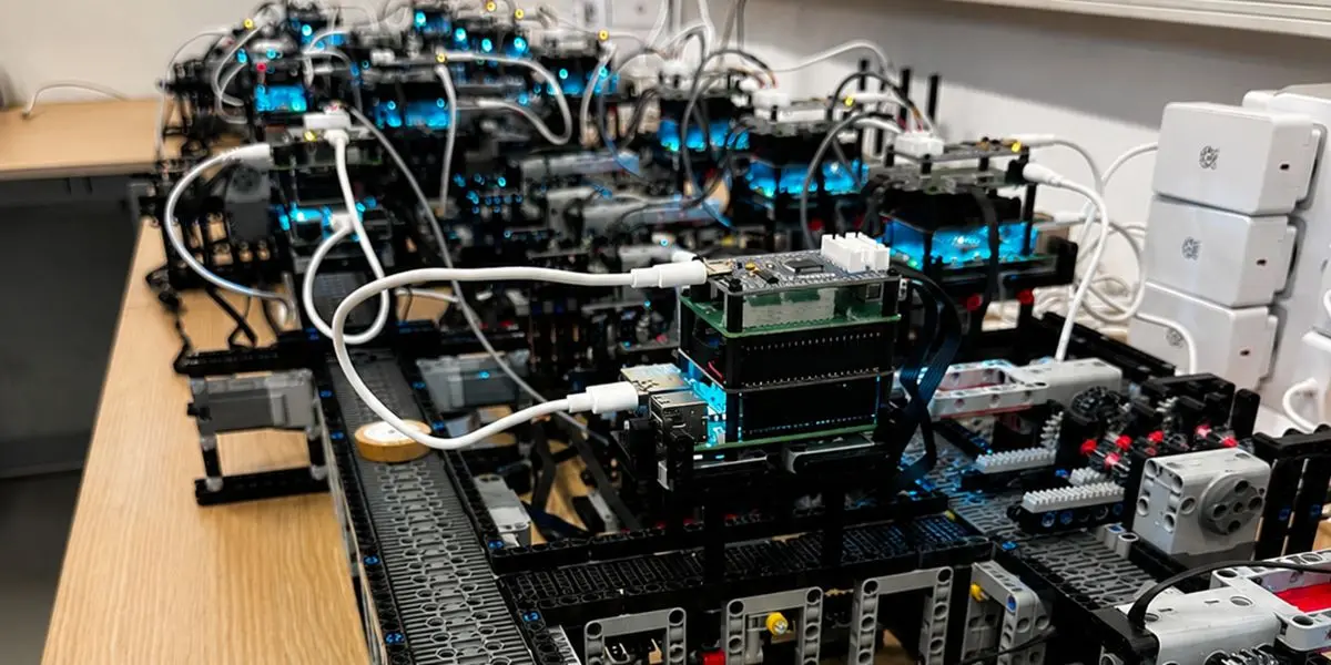 Close-up of interconnected modular robotic systems on a laboratory workbench.