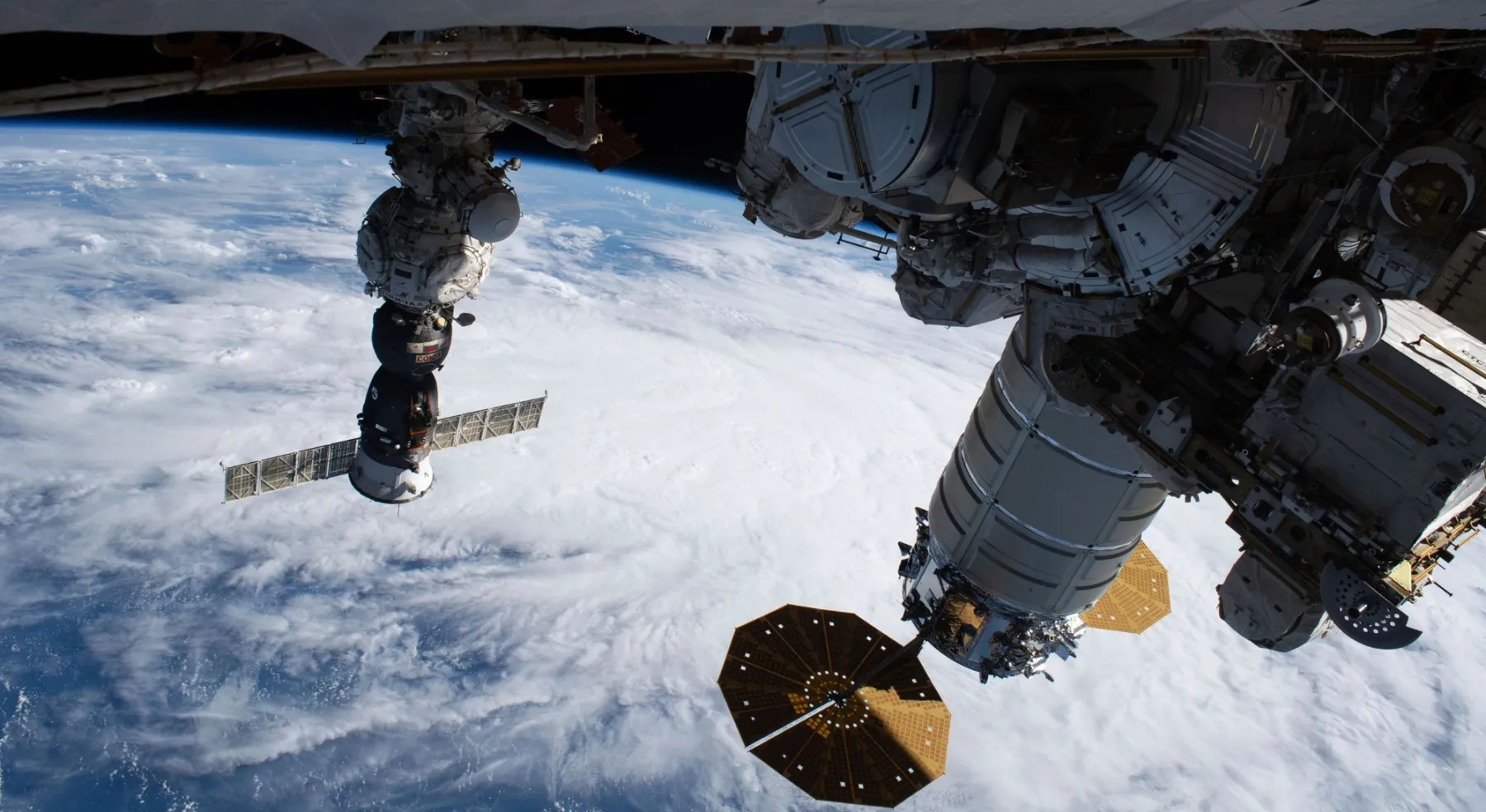Navetta Soyuz e moduli della Stazione Spaziale Internazionale in orbita sopra la Terra.