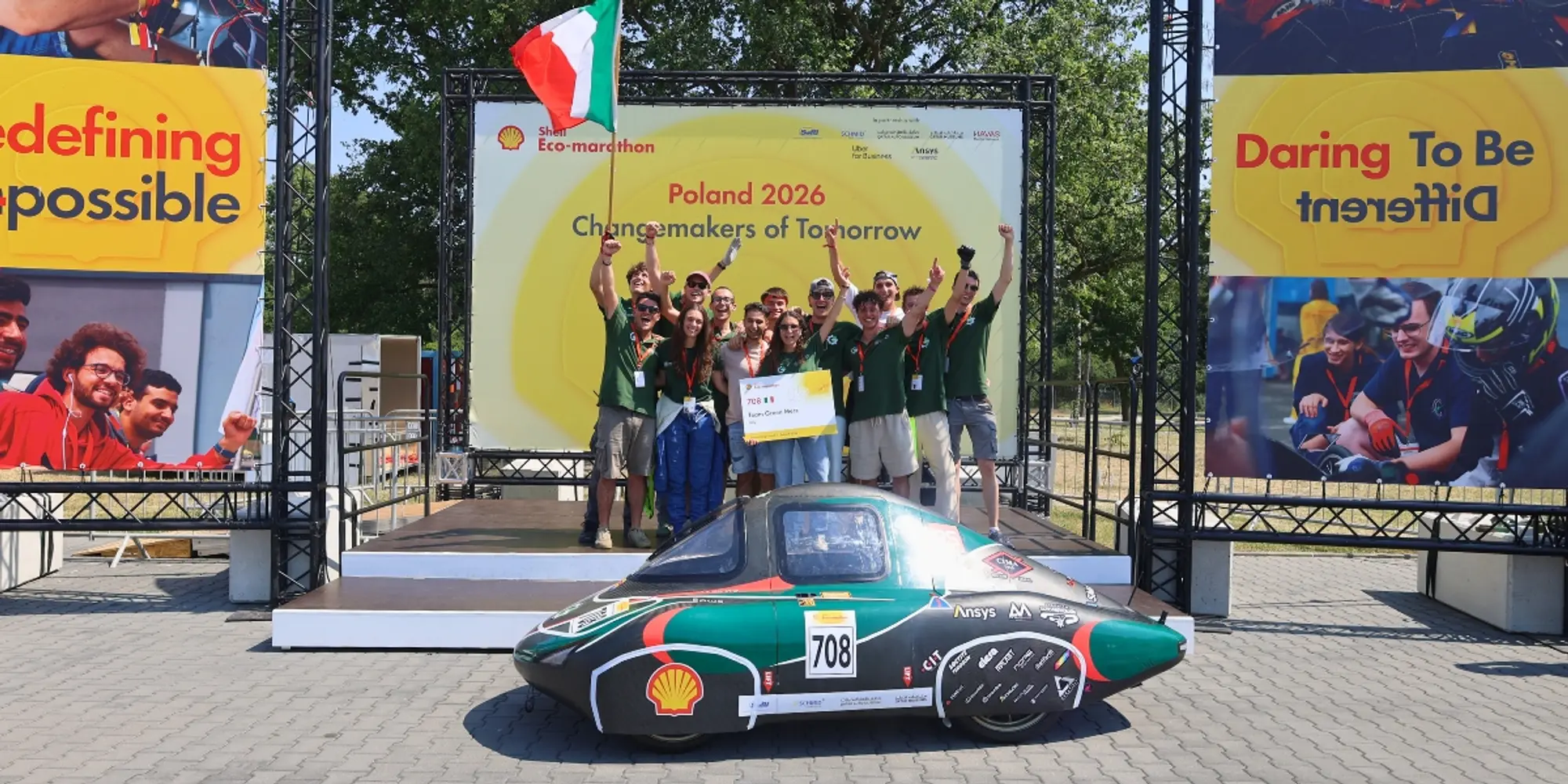 Team celebrating with vehicle number 708 and an award at the 2026 Shell Eco-marathon Poland.