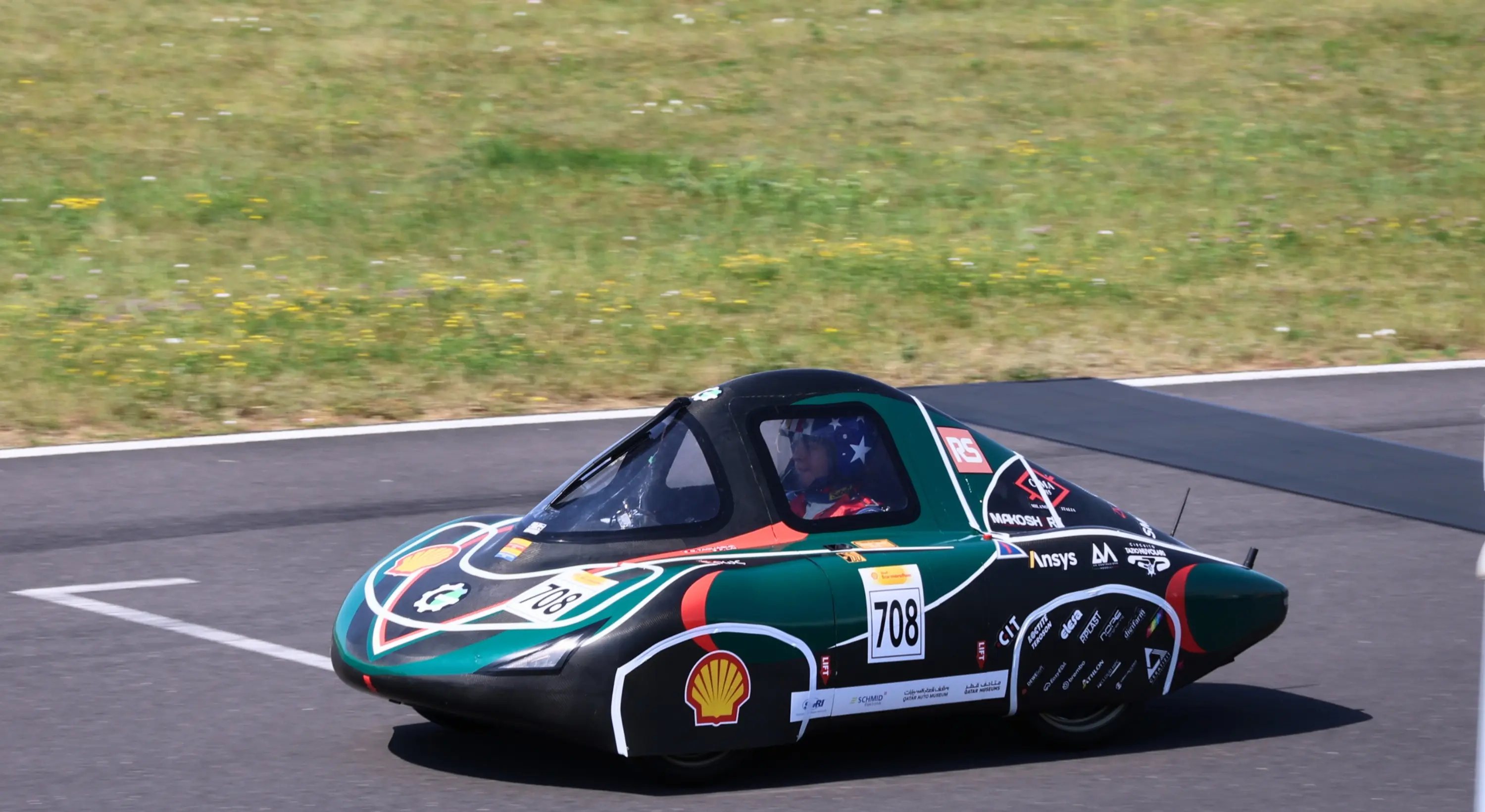 Experimental vehicle number 708 driving on a track during an energy-efficiency competition.