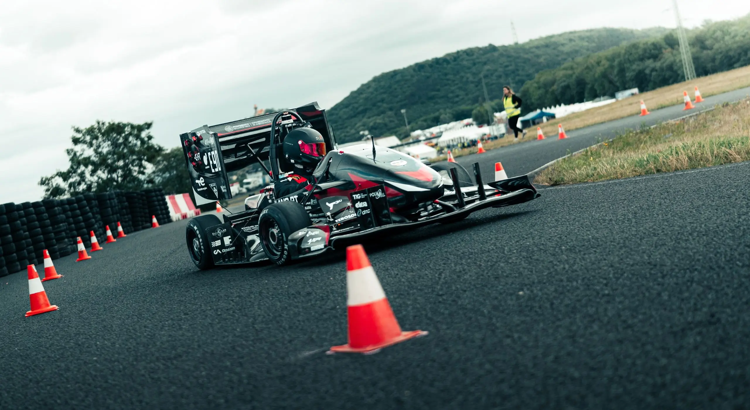 Monoposto di Dynamis PRC impegnata in una prova dinamica su un percorso delimitato da coni.