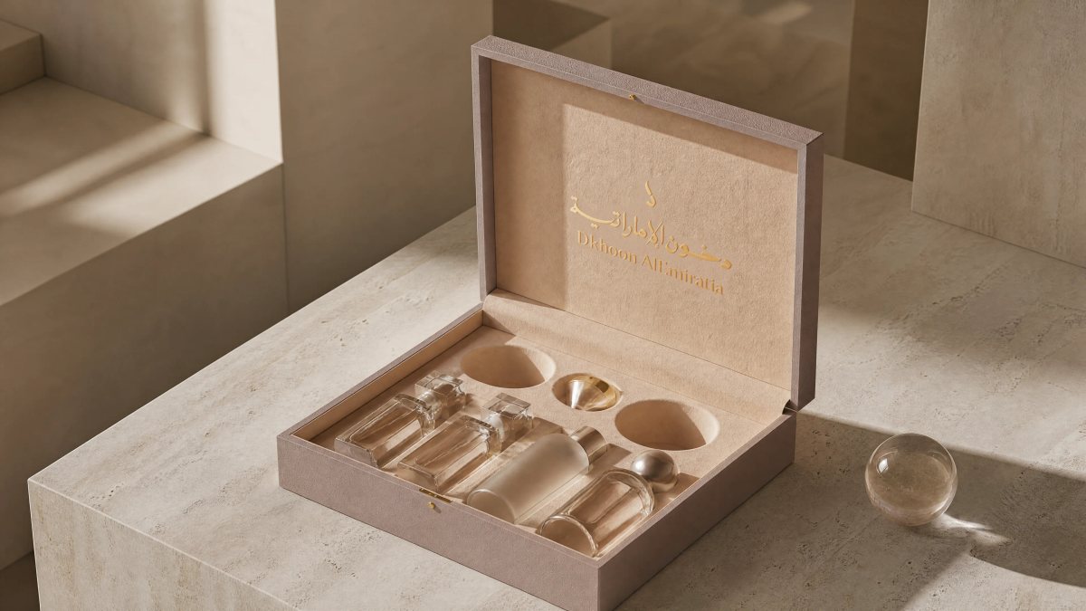 Fragrance gift box in a gifting setting, lid open and tray presented at reading angle.