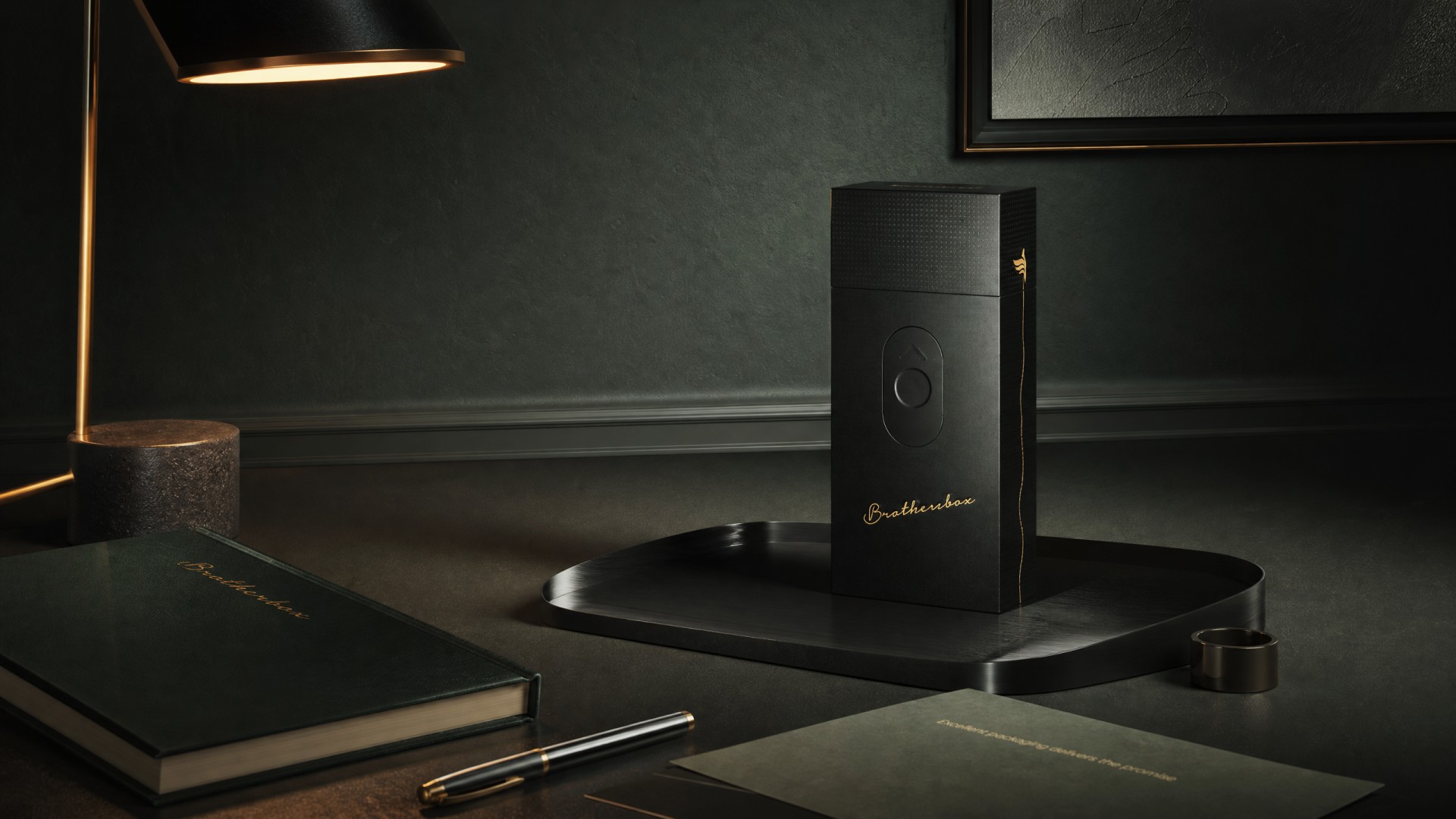 Finished Brothersbox packaging placed on luxury desktop scene with desk lamp, notebook and stationery, dim warm ambient lighting