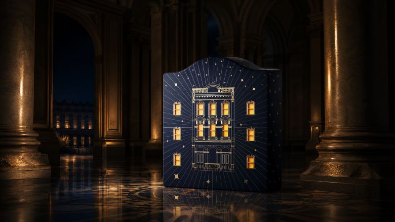 Midnight blue Christmas countdown box shaped as a palace facade with twelve lit windows.