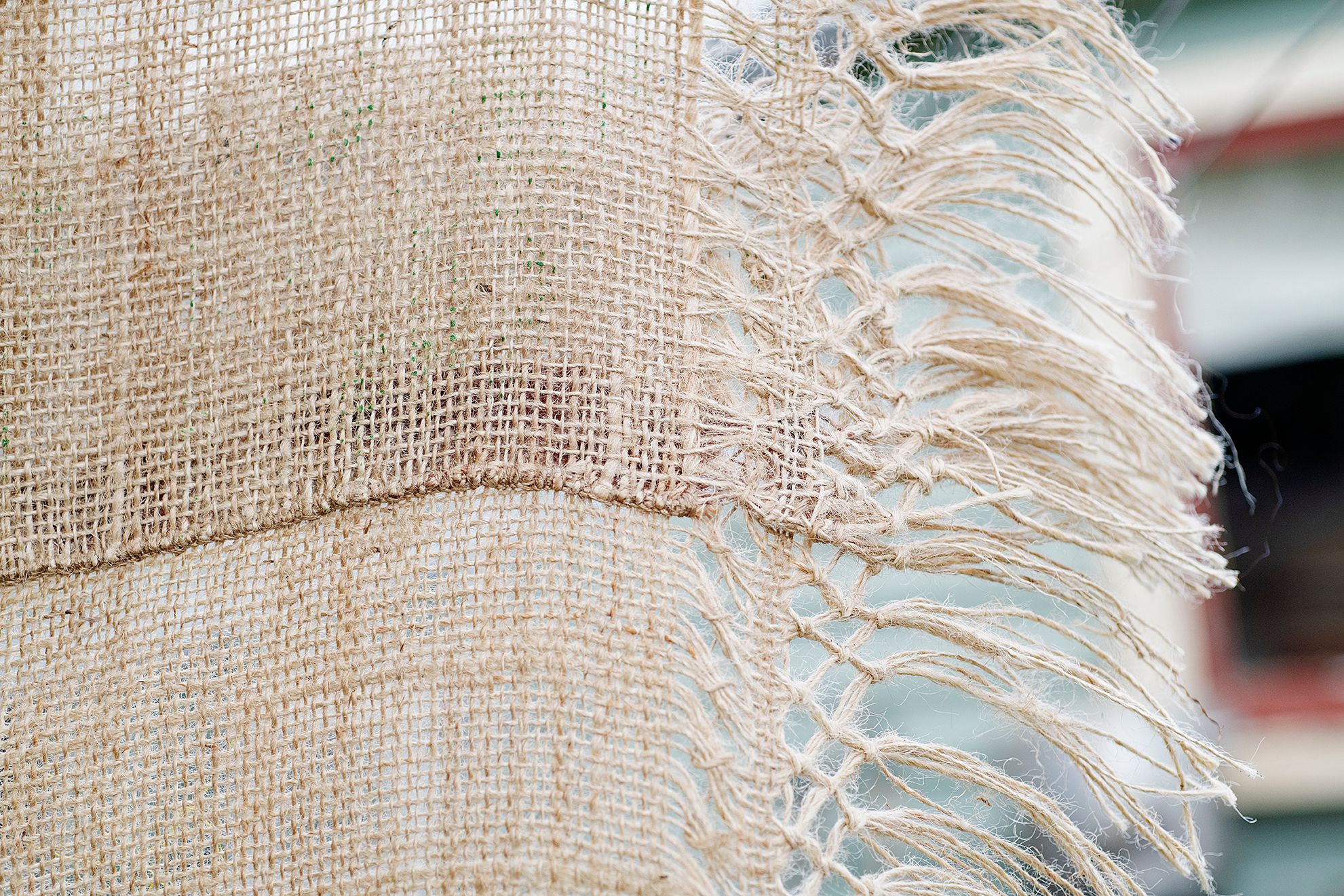 Quishile Charan, Burning Ganna Khet, 2021, cotton, embroidery thread, hessian sacks, natural dye: avocados, 153cm by 152cm. Close up of embroidery. Image taken by: Raymond Sagapolutele. 