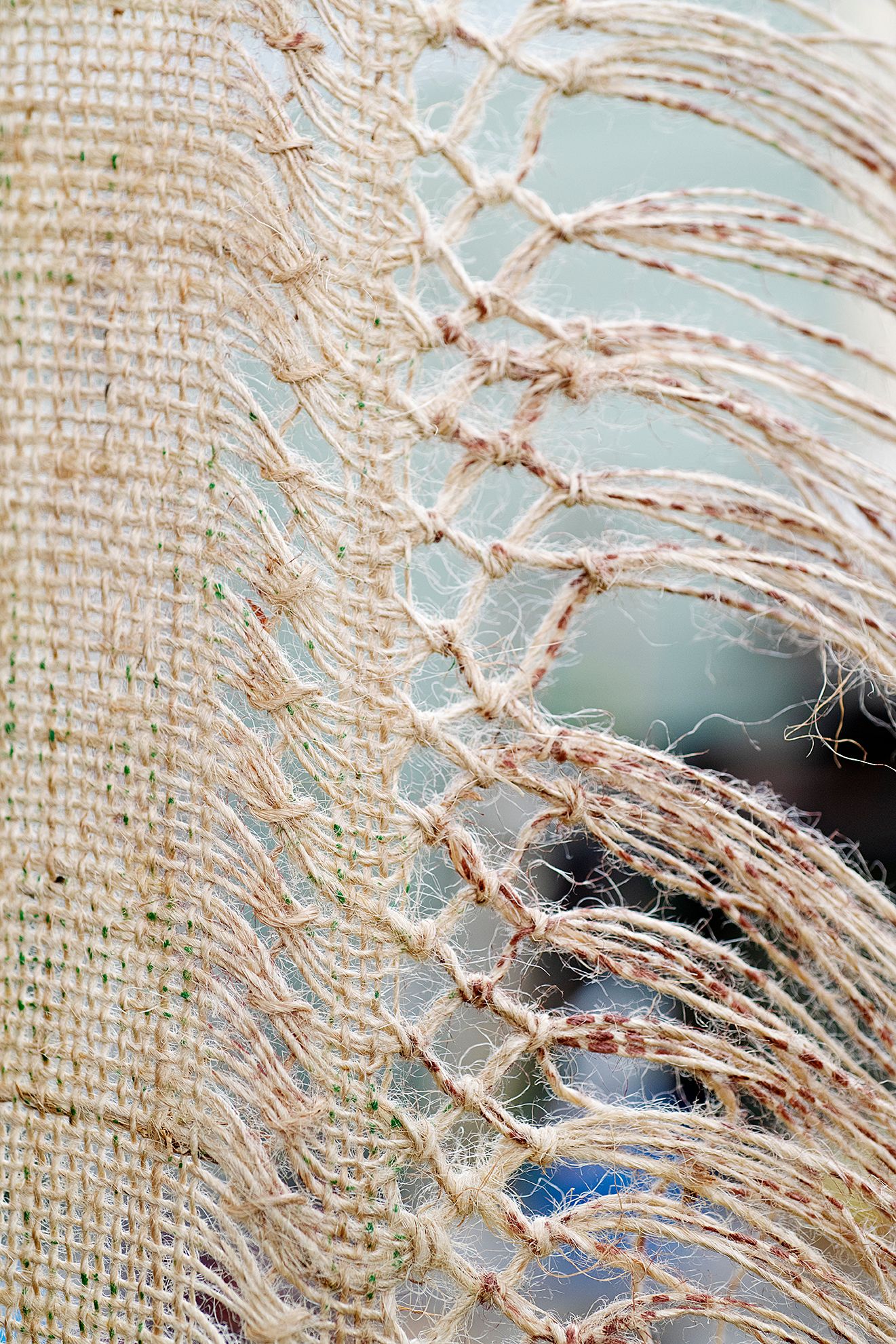 Quishile Charan, Burning Ganna Khet (Burning Sugarcane Farm), 2021, 153cm by 152cm, close up of weaving detail. Technique: hand dyed textile, embroidery thread, cotton, hessian sacks. Textile is naturally dyed with avocado seeds. Image taken by: Raymond Sagapolutele. 