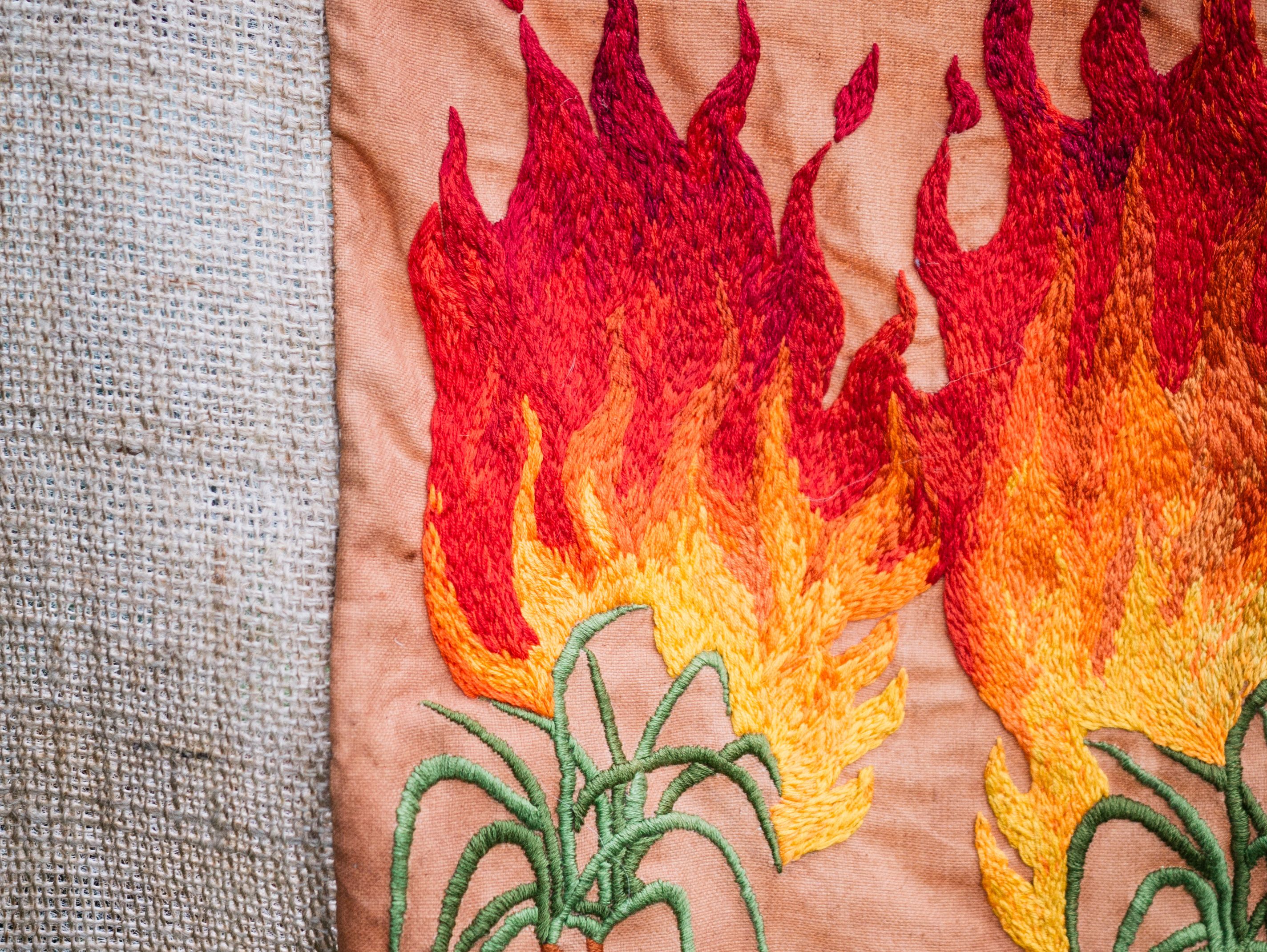 Quishile Charan, Burning Ganna Khet (Burning Sugarcane Farm), 2021, 153cm by 152cm. Technique: hand dyed textile, embroidery thread, cotton, hessian sacks. Textile is naturally dyed with avocado seeds. Image by Matavai Taulangau.