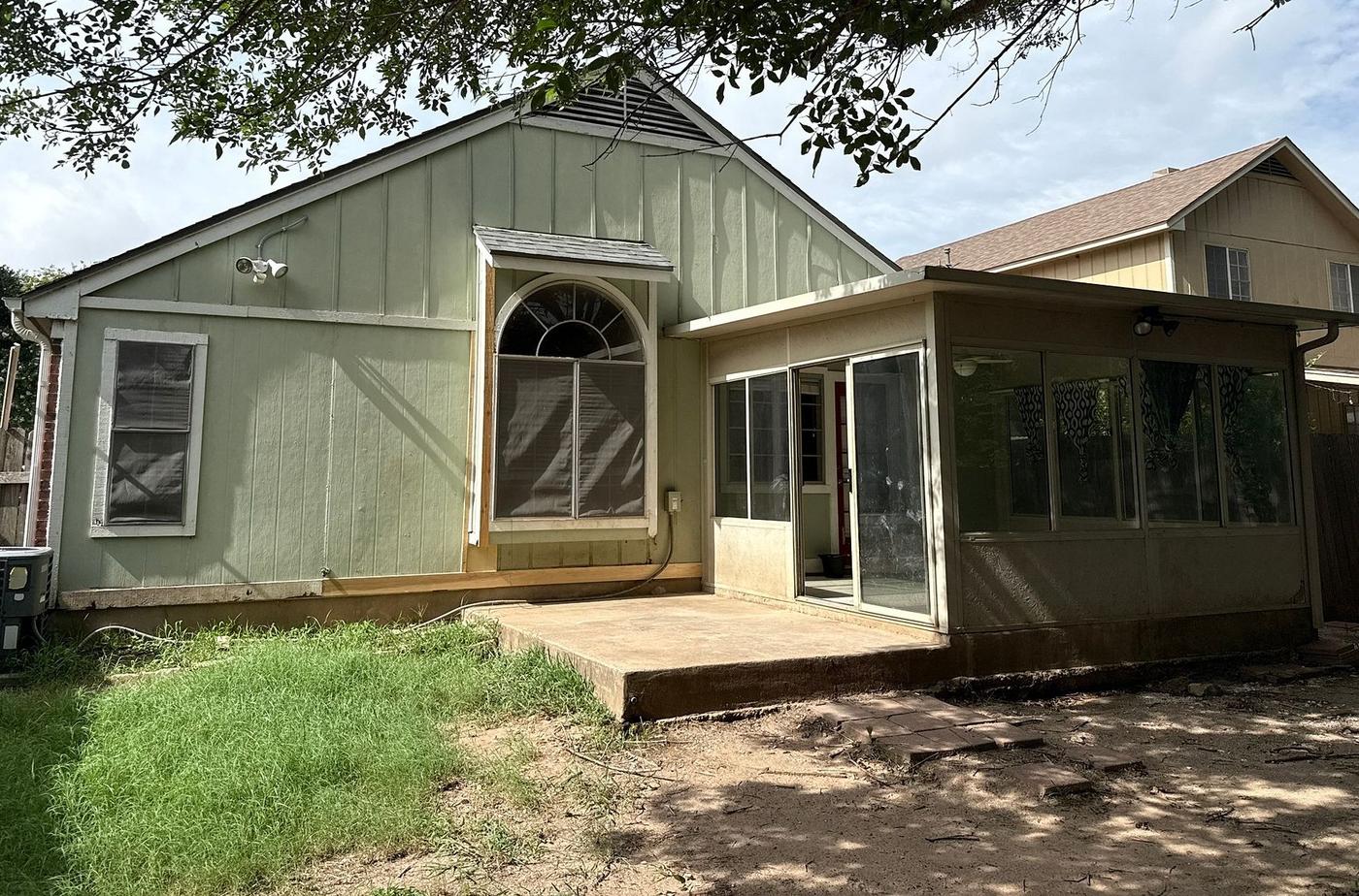 Before the siding & exterior painting project — home exterior in Scofield Farms, Austin