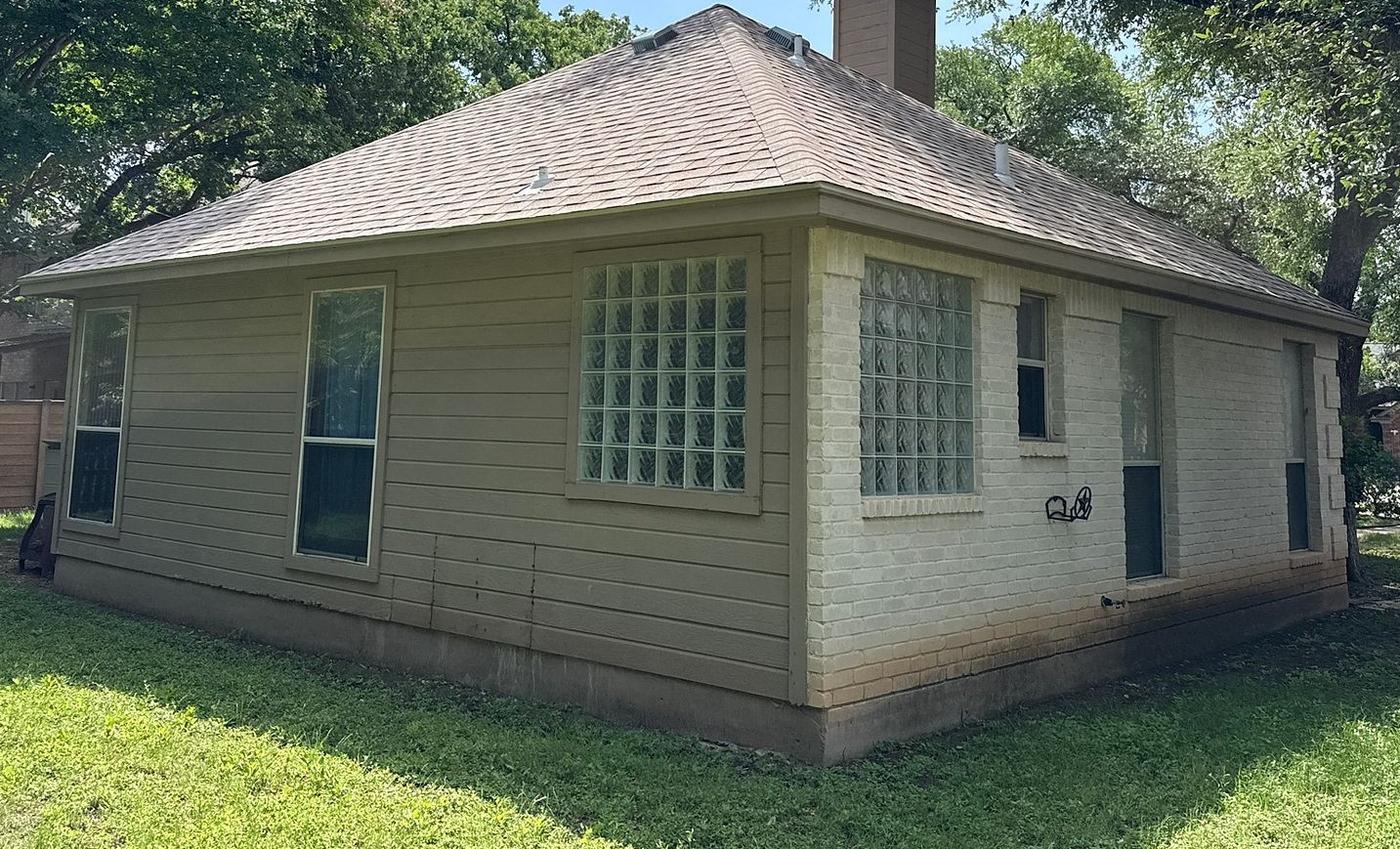 Before the siding project — home exterior in The Woods, Round Rock