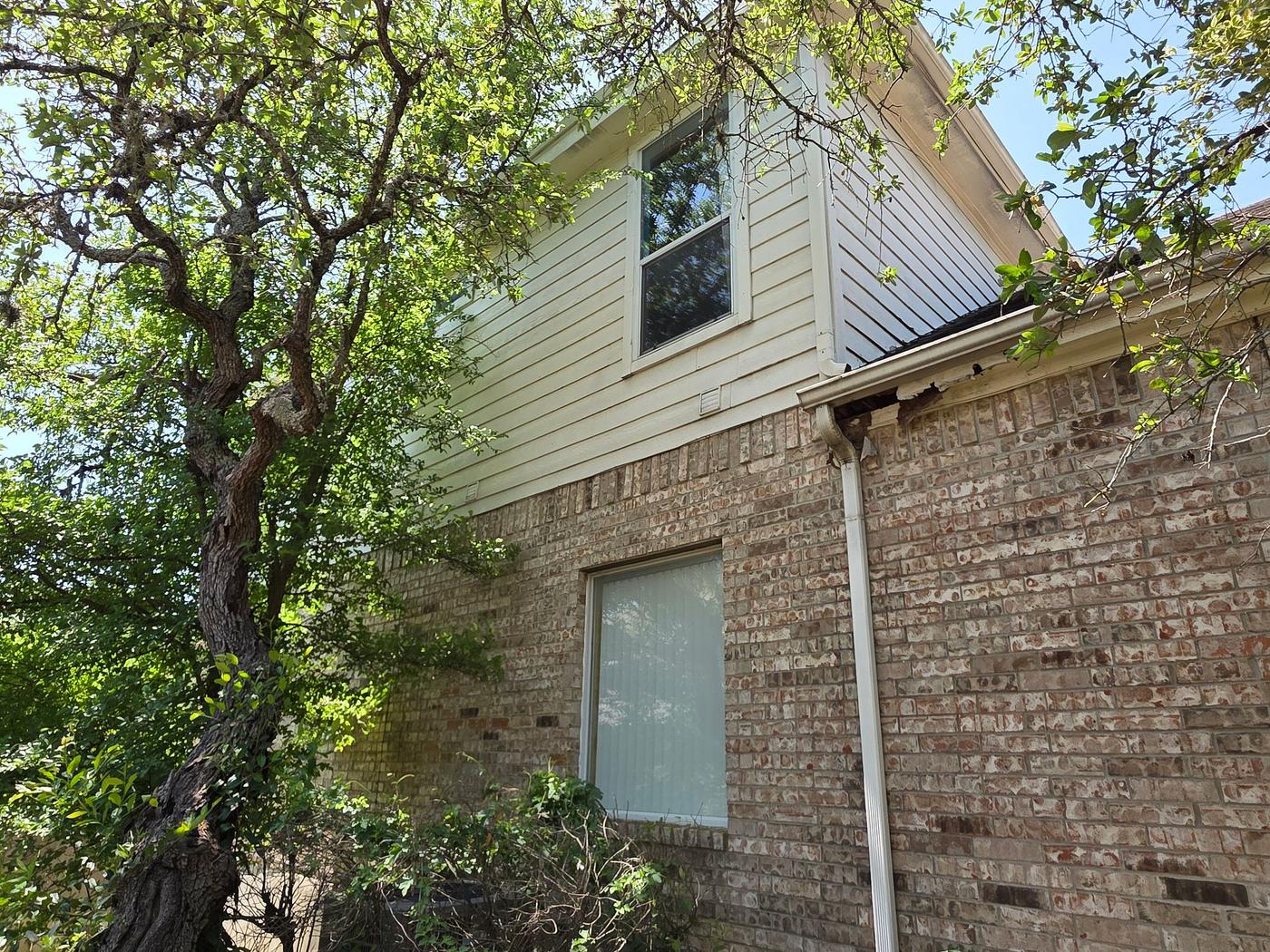 Before the siding & windows project — home exterior in Travis Country, Austin
