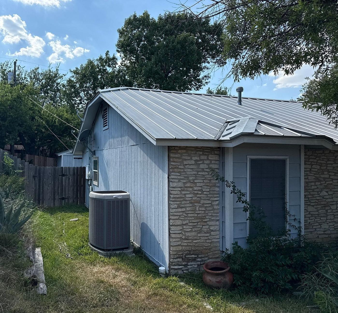 Before the siding & exterior painting project — home exterior in Chisholm Valley West, Round Rock