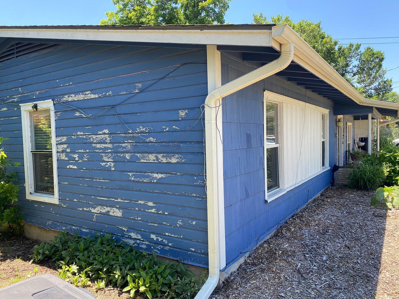 Before the siding & exterior painting project — home exterior in Govalle, Austin