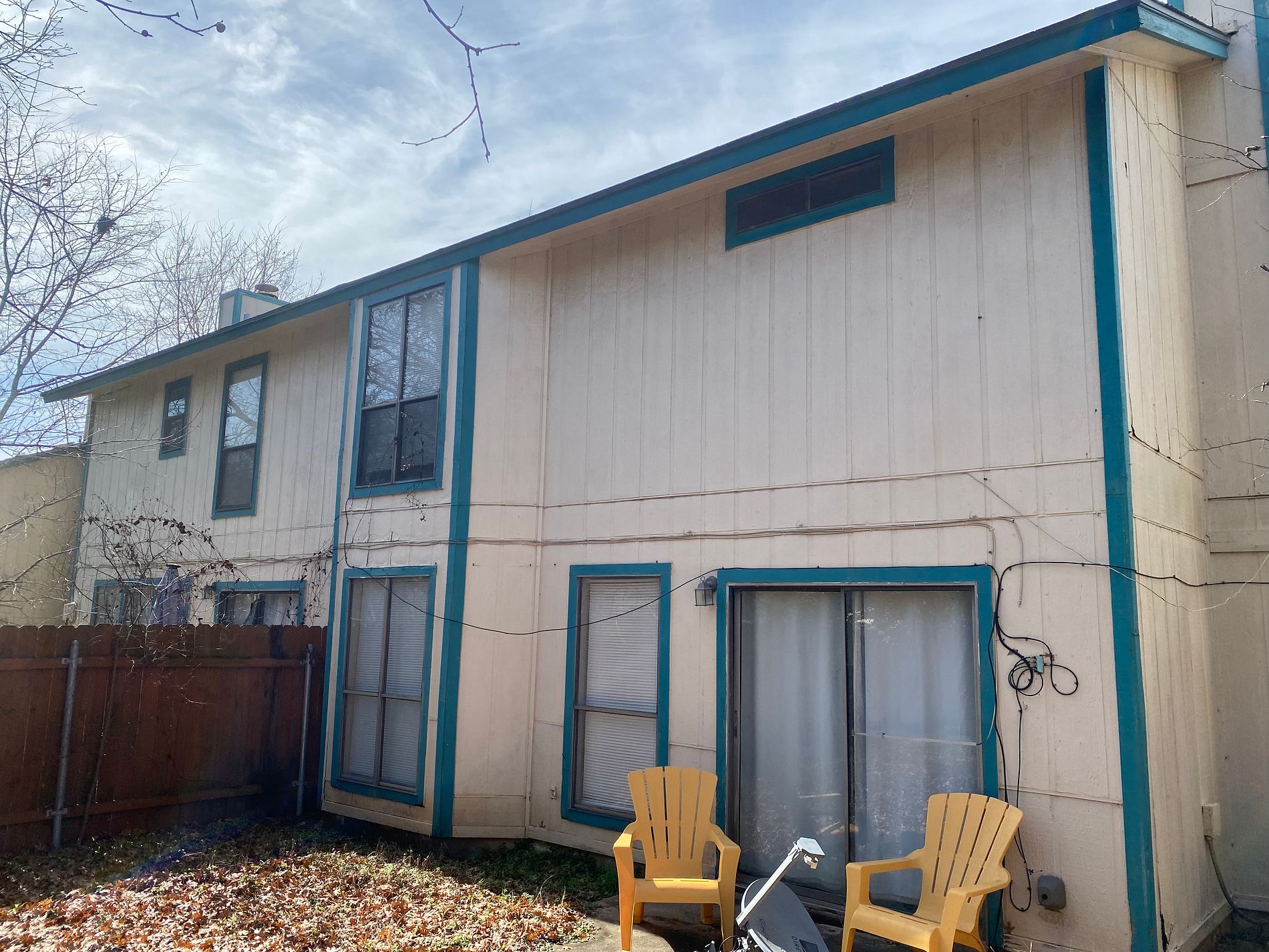 Before the siding & exterior painting project — home exterior in Tanglewood Forest, Austin