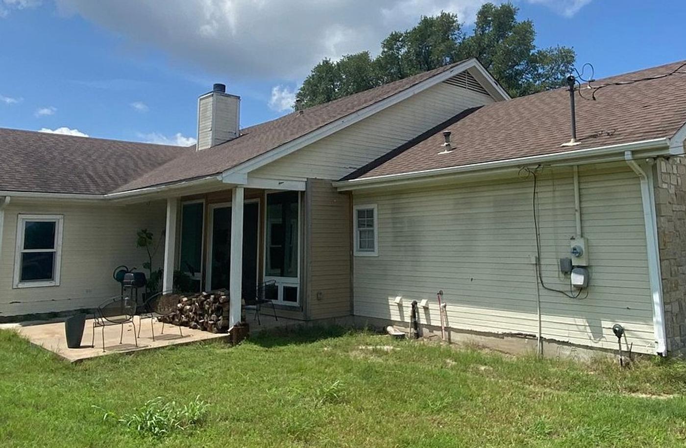 Before the siding & gutters project — home exterior in Austin, Dripping Springs