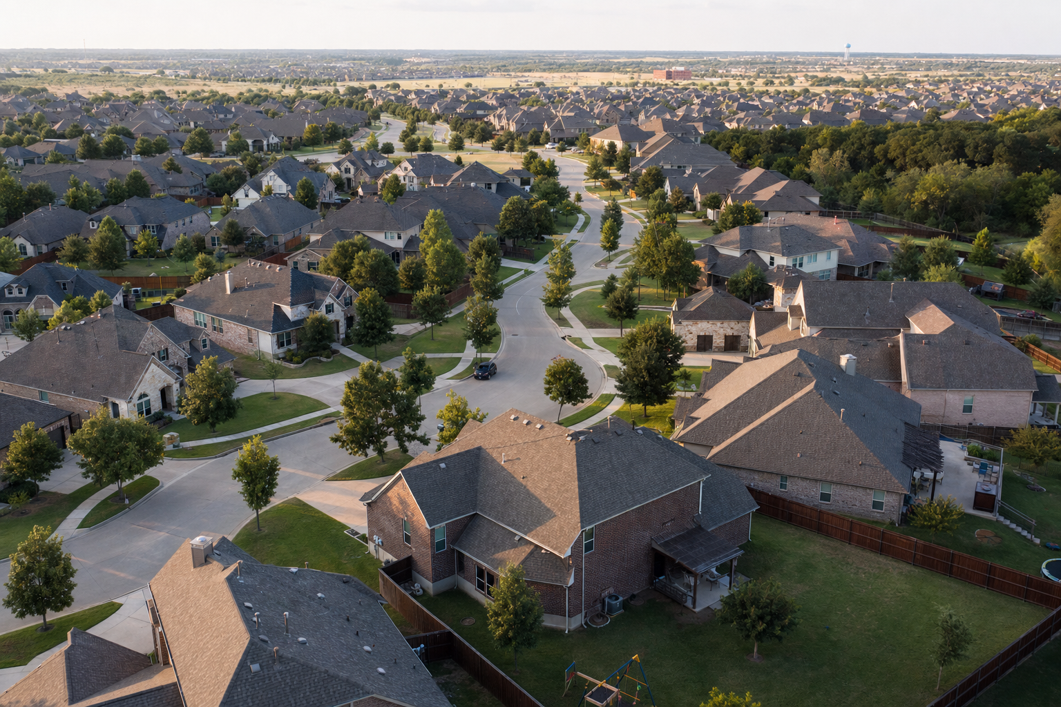 Aerial view of a master-planned Cedar Park neighborhood with rows of suburban homes and tree-lined streets.
