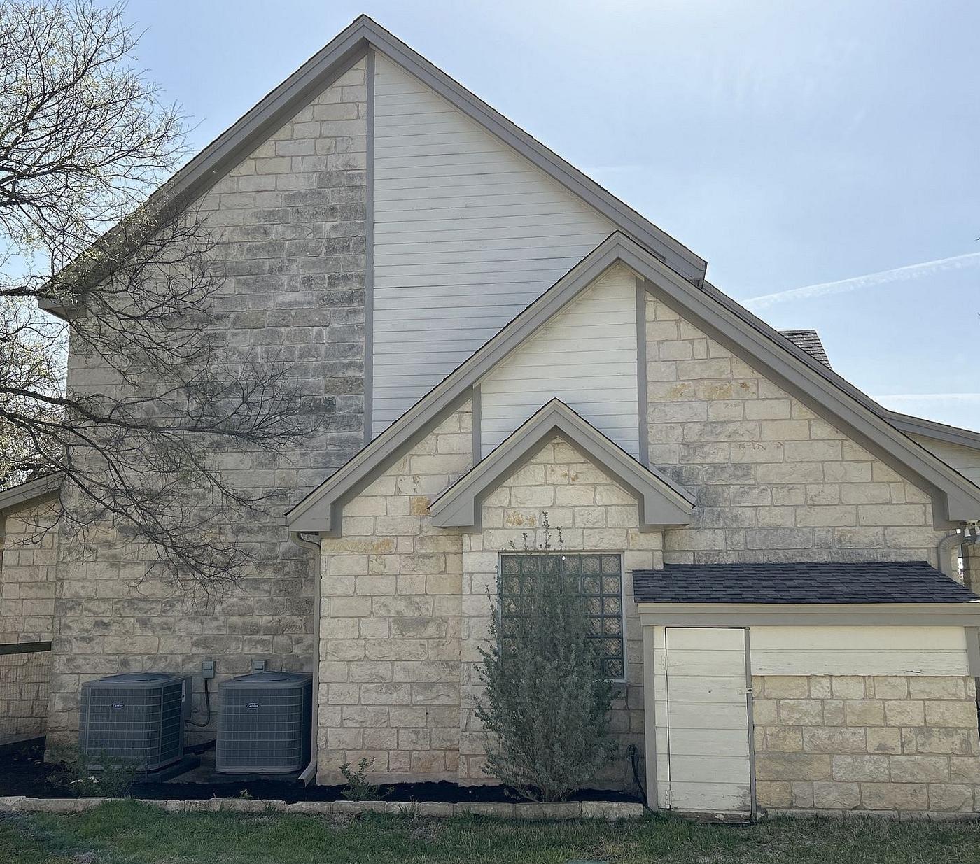 Before the siding & exterior painting project — home exterior in Driftwood, Austin