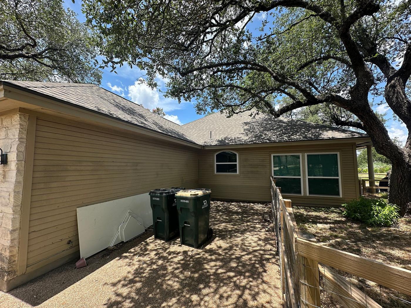 Before the siding & gutters project — home exterior in Austin