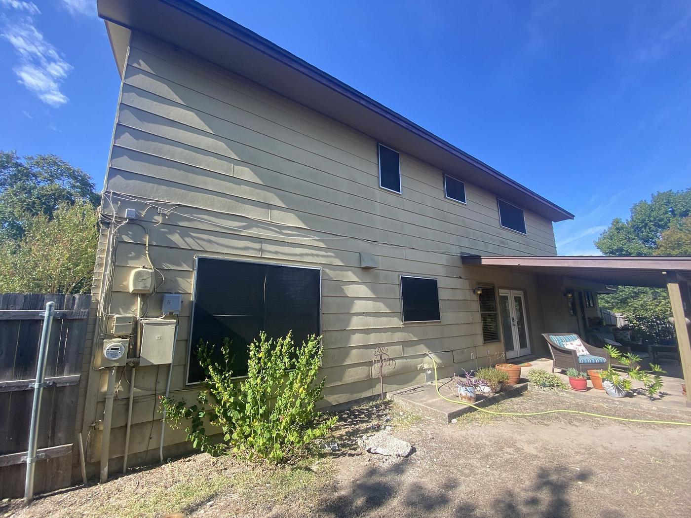 Before the siding & exterior painting project — home exterior in Heritage Hills, Austin