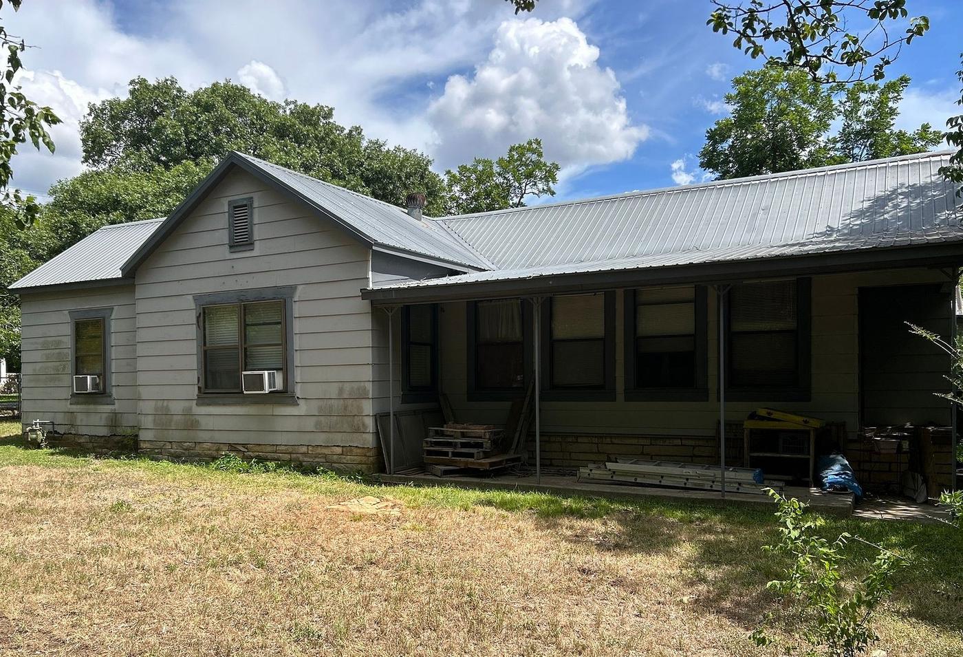 Before the windows & siding project — home exterior in Buda