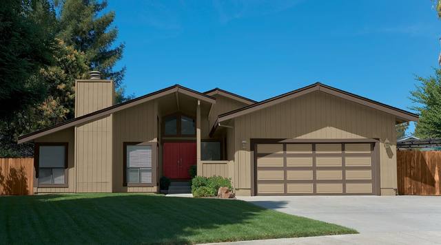 Ranch home in khaki vertical board siding with brown trim and a red double front door, from Sherwin-Williams’ exterior color gallery
