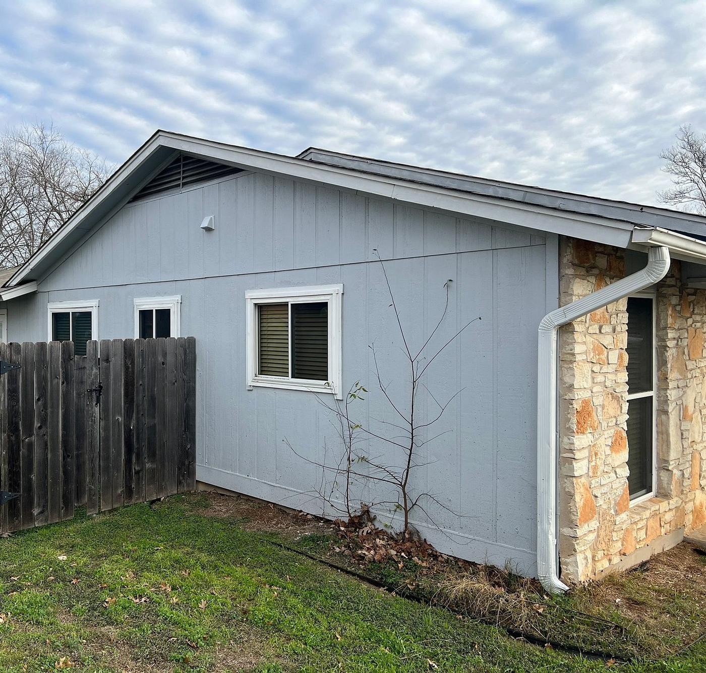 Before the siding & exterior painting project — home exterior in Village At Anderson Mill, Austin