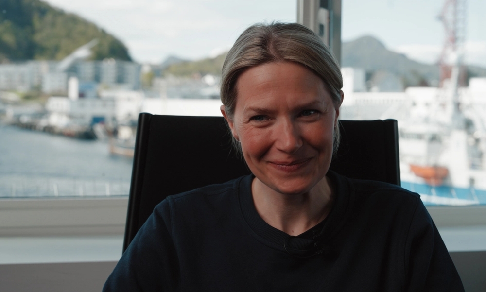 Kvinne i kontorstol som smiler