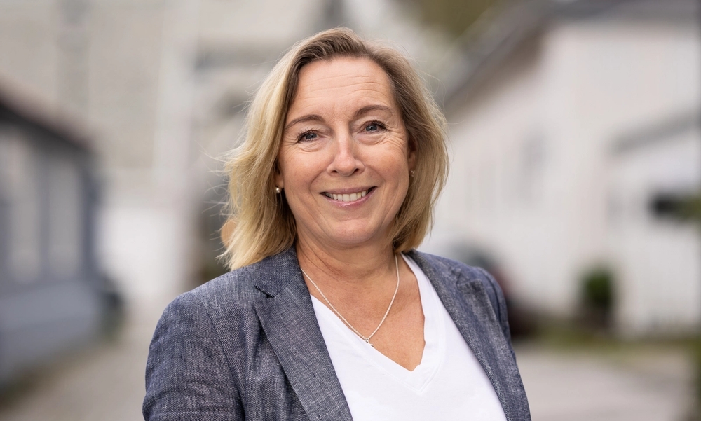 Kvinne e hvit t-skjorte og grå dressjakke