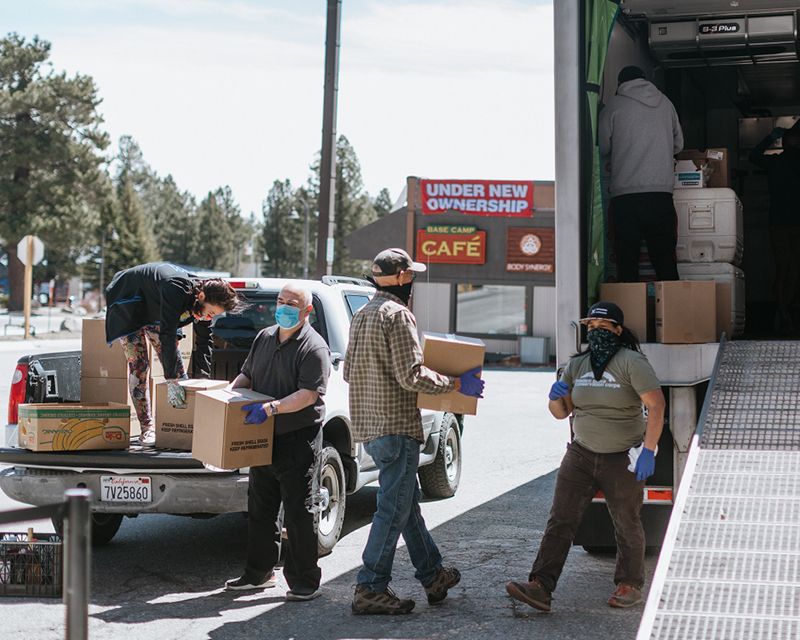 Group of people loading a truck with boxes of donations