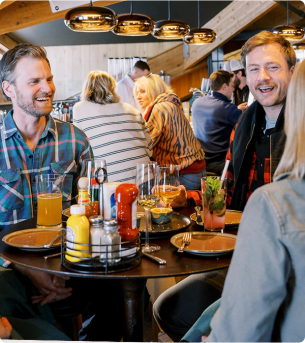Group of friends eating at a restaurant with KraftHeinz products on the table
