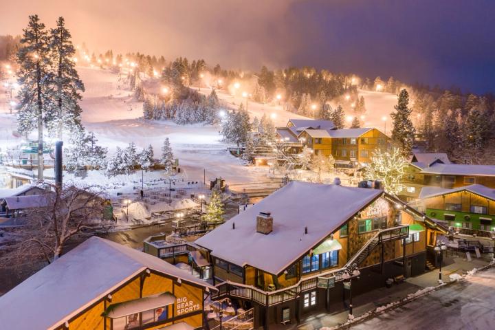Base of a snowy ski resort at night