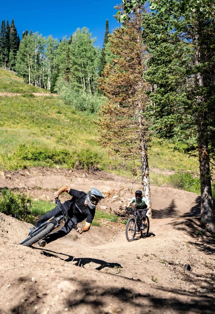 Two people riding mountain bikes on a dirt trail