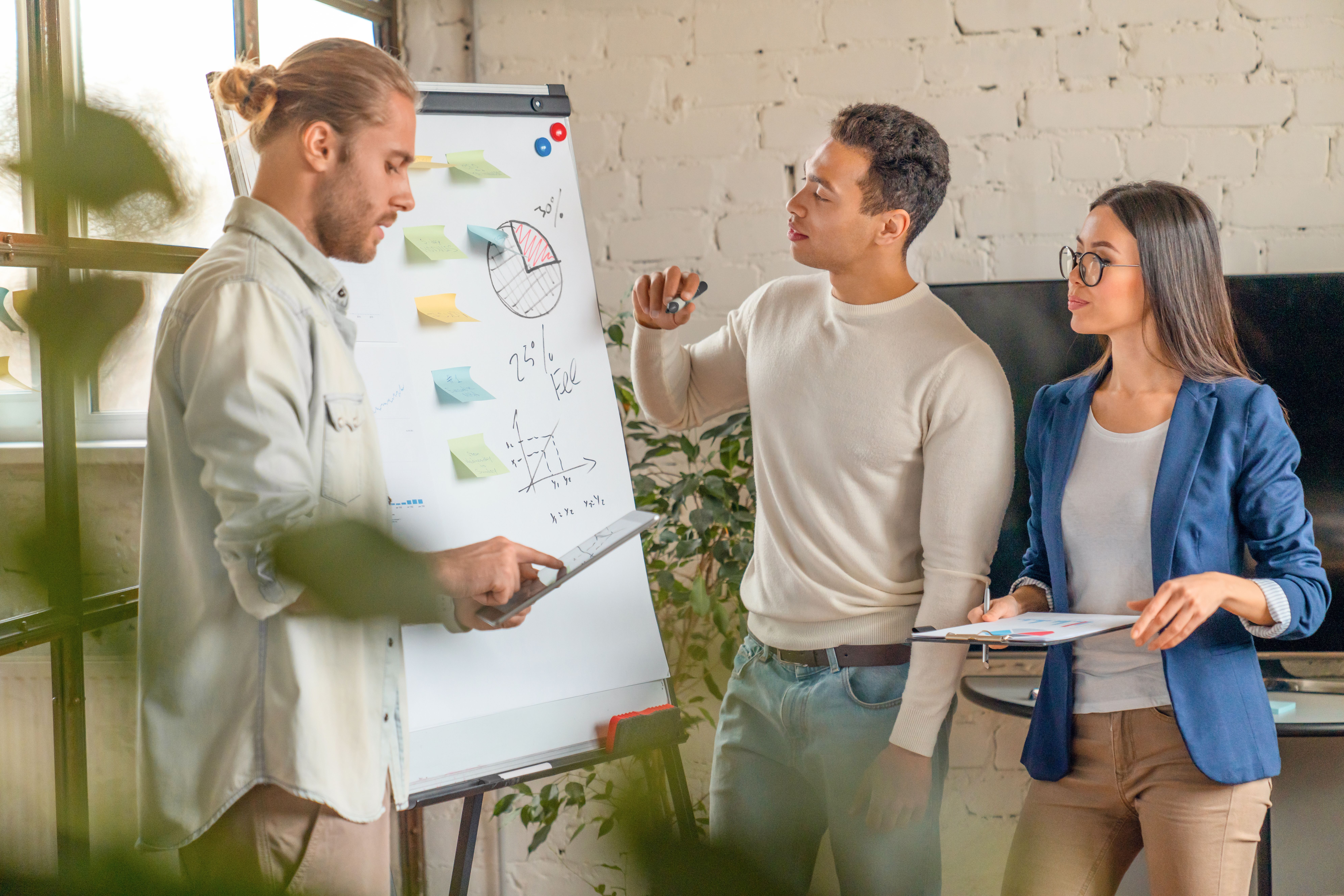 young man standing by flipchart