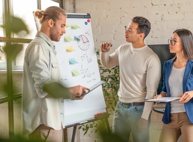 young man standing by flipchart