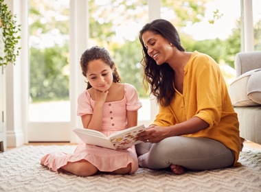 mother and daugther at home sitting on floor