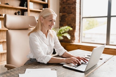 Woman working typing salary on laptop computer
