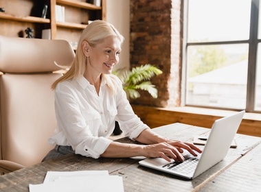 Woman working typing salary on laptop computer