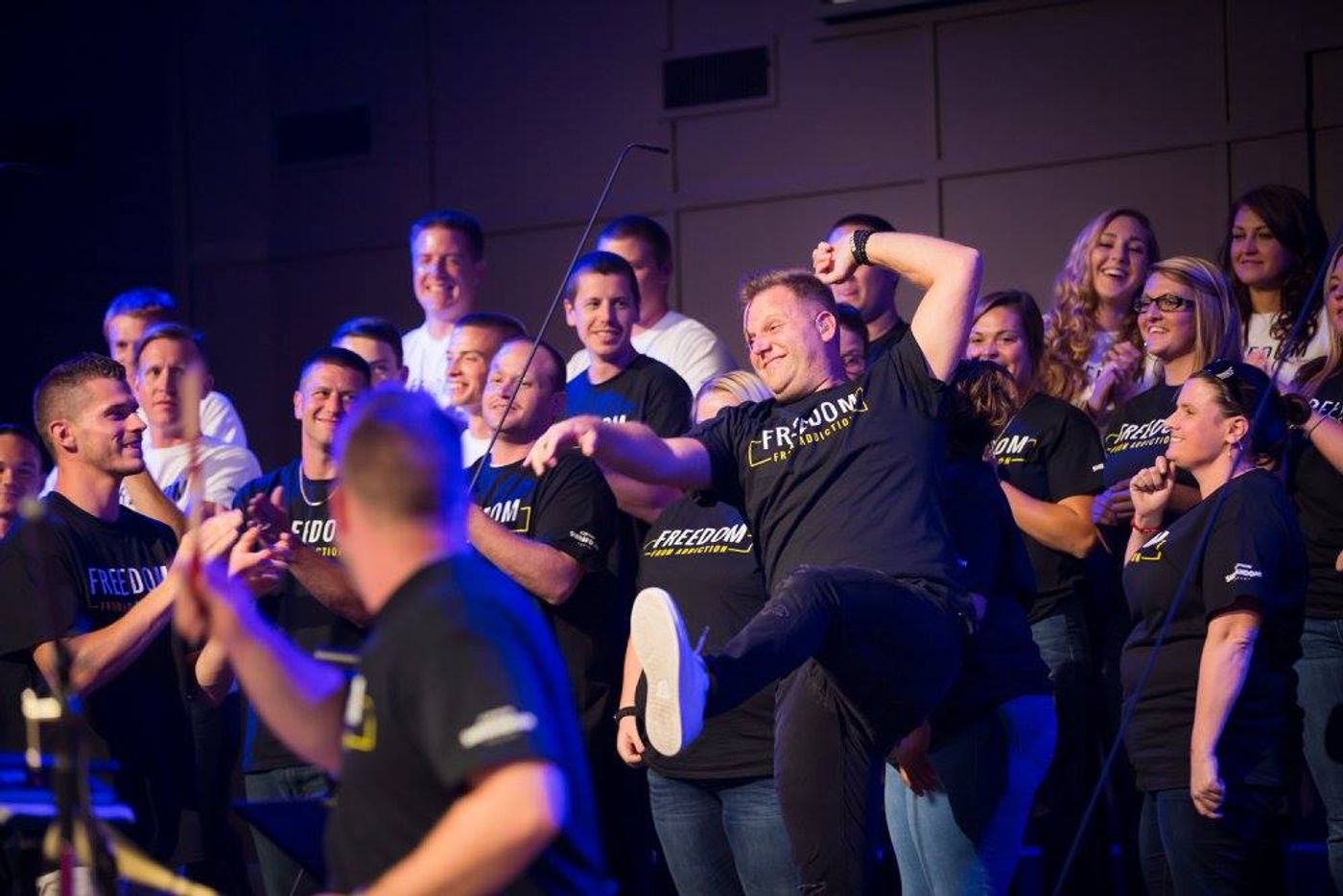 SVTC students in Freedom From Addiction shirts laughing and dancing on stage during Matthew West concert at Winchester Church of God