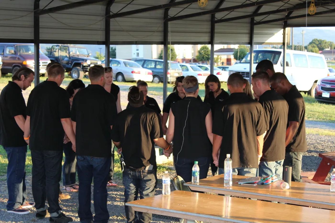 SVTC students and staff holding hands in a prayer circle at the Shenandoah County Fairgrounds before the Third Day concert